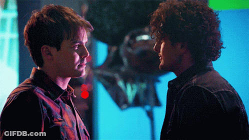 Two Men Looking At Each Other With Balloon GIF