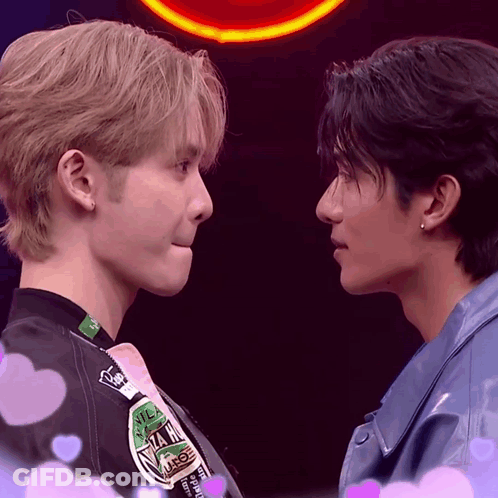 Two Men Looking At Each Other With N.I.M. Jacket GIF