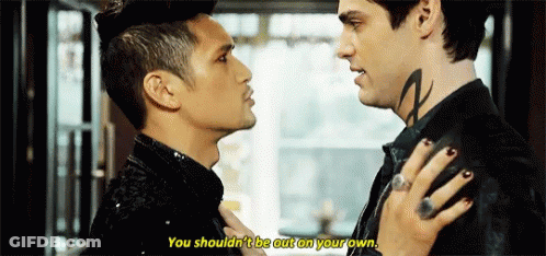 Two Men Looking At Each Other With Neck Tattoo GIF