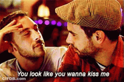 Two Men Looking At Each Other With Words You Look Like You Wanna Kiss Me GIF