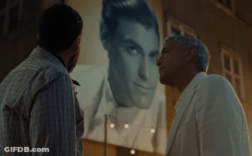 Two Men Looking At Man In White Suit GIF
