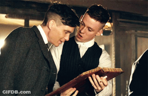 Two Men Looking At Paper Together GIF