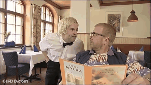 Two Men Looking At Plaza Mocha Menu GIF