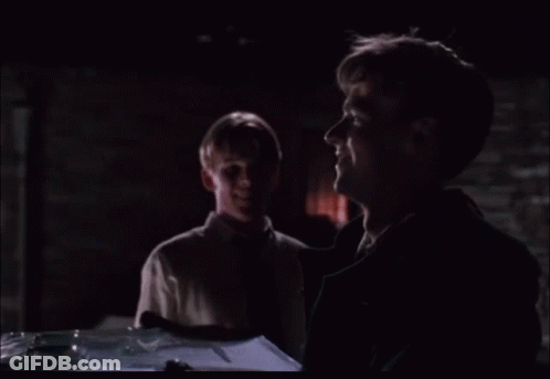 Two Men Looking At Something In Dark Room GIF