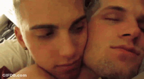 Two Men Lying On Bed Kissing GIF