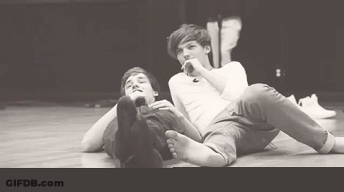 Two Men Lying On Floor With Feet Up GIF