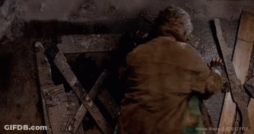Two Men Lying On Ground Covered In Paint And Gloves GIF