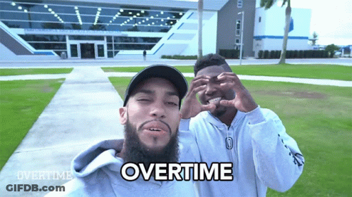 Two Men Making A Heart Shape With Their Hands And The Word Overtime Written On The Bottom GIF