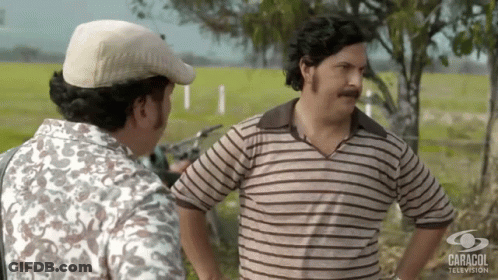 Two Men Next To Caracol Television GIF