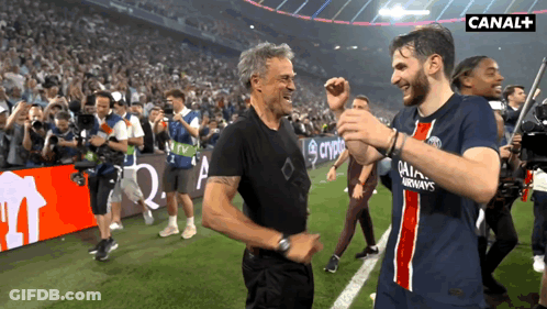 Two Men On A Soccer Field With Canal + In The Upper Right Corner GIF