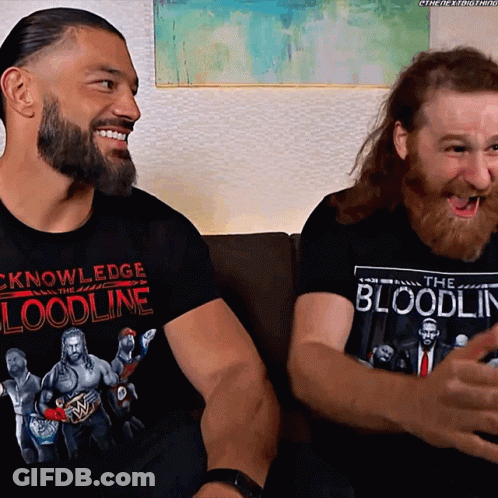 Two Men On Couch, Shirt Says Knowledge Bloodline GIF