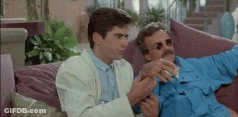 Two Men On Couch Talking One Smoking GIF