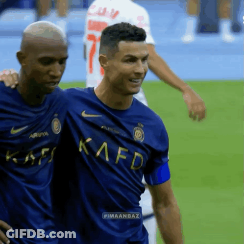 Two Men On Field One Blue Kafd Shirt GIF