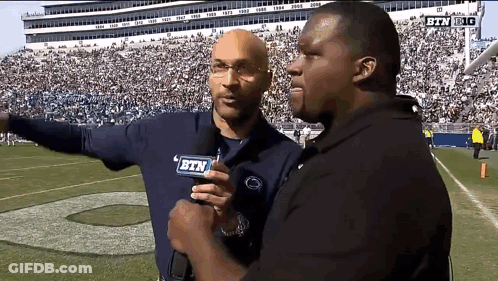 Two Men On Football Field With BTN Mic GIF