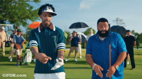 Two Men On Golf Course One With Number 21 On Sleeve GIF