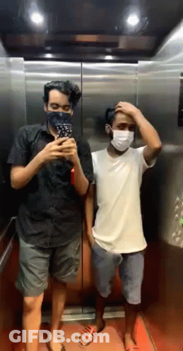 Two Men On Phones, One In Kona Shirt GIF