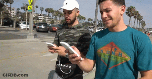 Two Men On Phones One Kona Hawaii Shirt GIF