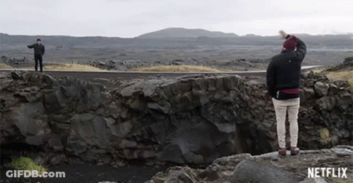 Two Men On Rocky Cliff With Netflix Logo GIF