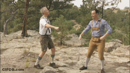 Two Men On Rocky Hillside One In Brown Pants GIF