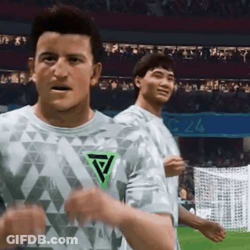 Two Men On Soccer Field One With Green Triangle Shirt GIF