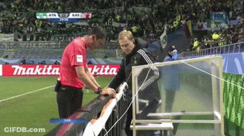 Two Men On Soccer Field With Makita Advertisement GIF