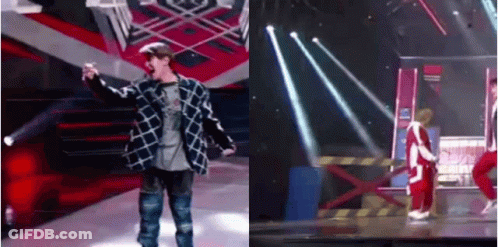 Two Men On Stage One With Microphone GIF