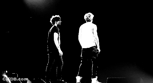 Two Men On Stage With Microphones GIF