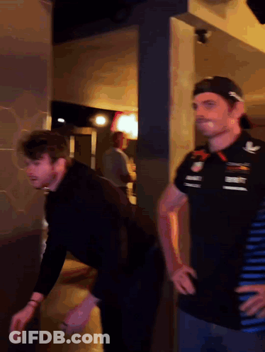 Two Men, One In Red Bull Shirt GIF