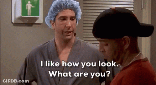 Two Men, One Wearing Surgical Cap And Robe GIF