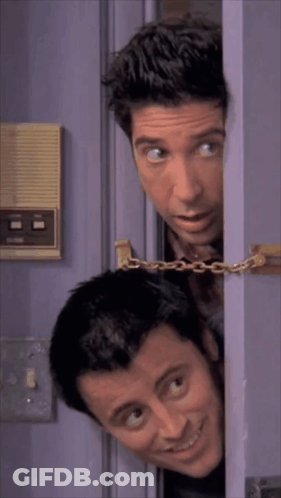 Two Men Peeking Out Of A Purple Door With A Chain Around Them GIF