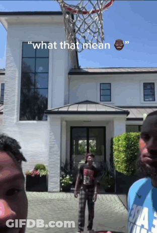 Two Men Playing Basketball In Front Of A White House With The Words " What That Mean " On The Bottom GIF