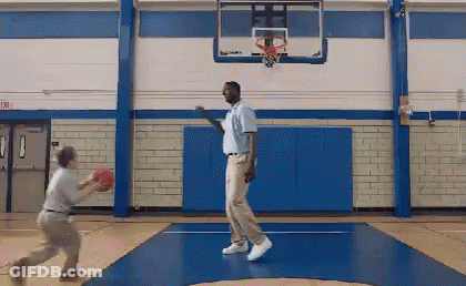Two Men Playing Basketball In Gym With Exit Sign GIF