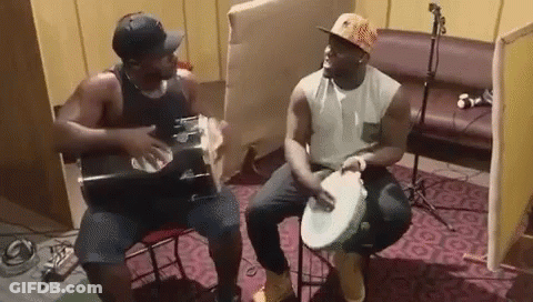Two Men Playing Drums And Guitar GIF