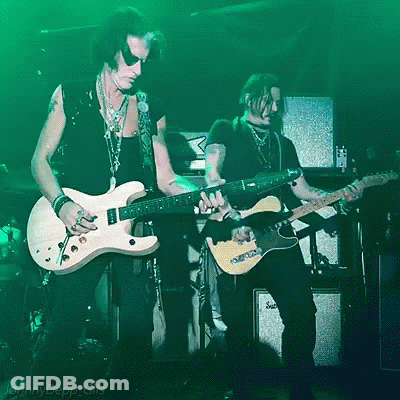 Two Men Playing Guitars In Front Of A Green Background That Says Jenny Depp Gifs On It GIF