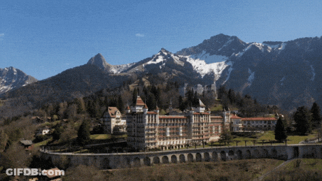 Two Men Playing Horns By Mountain Range GIF