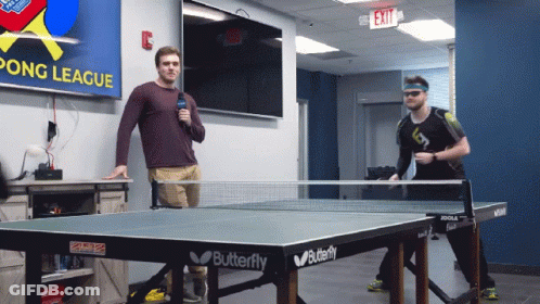 Two Men Playing Ping Pong In Front Of A Pong League Sign GIF