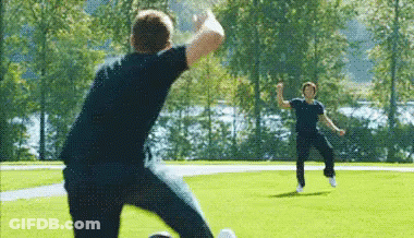 Two Men Playing Soccer One Kicking Ball GIF