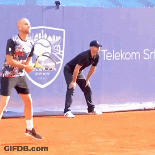 Two Men Playing Tennis In Front Of Telekom Ad GIF