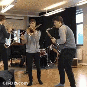 Two Men Playing Trombone And Saxophone GIF