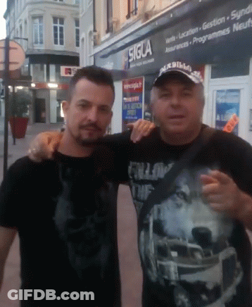 Two Men Posing For A Picture In Front Of A Sigla Store GIF