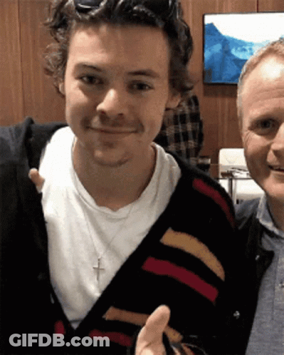 Two Men Posing For Picture One With Cross Necklace GIF