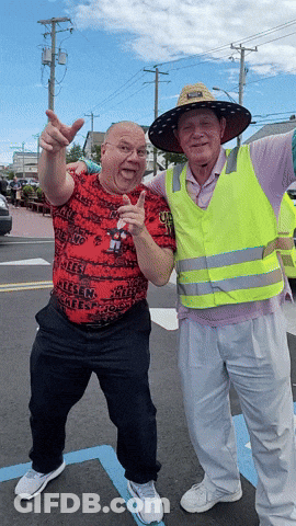 Two Men Posing One Wearing Reese Shirt GIF