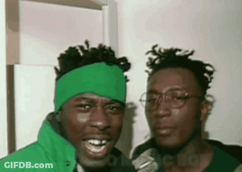 Two Men Posing One With Green Headband GIF