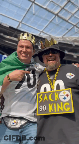 Two Men Posing With 90 King Sign GIF