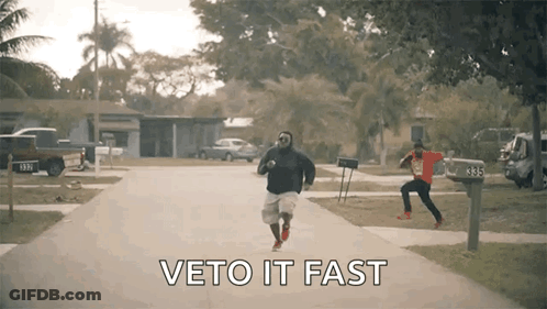 Two Men Running Down Street Saying Veto It Fast GIF