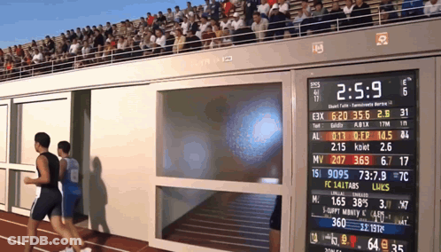 Two Men Running On Track With Scoreboard 2:5.9 GIF