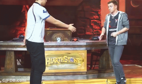Two Men Shake Hands In Front Of A Hearthstone Sign GIF