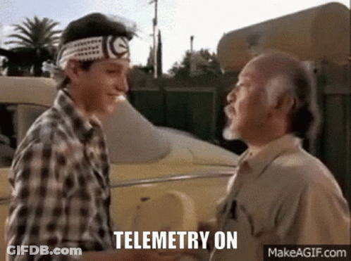 Two Men Shaking Hands In Front Of A Car With The Words Telemetry On Written Below Them . GIF