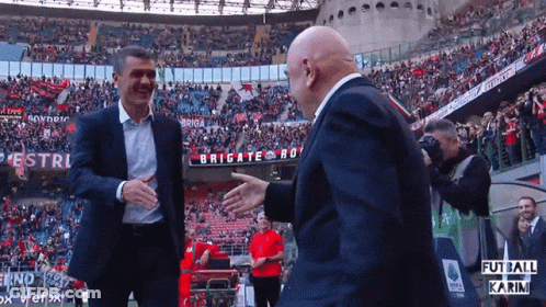 Two Men Shaking Hands In Front Of Brigate Sign GIF