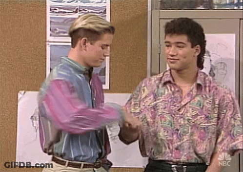 Two Men Shaking Hands In Front Of Bulletin Board GIF